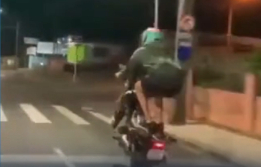 Motociclista cai após ficar em pé em moto em movimento; veja vídeo