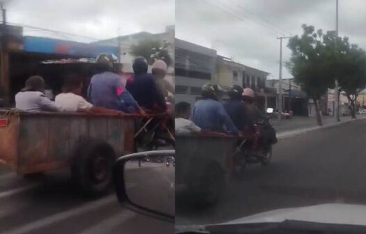Motociclista é visto rebocando carrinho de reciclagem com três pessoas em avenida de Fortaleza